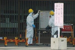 Guards at whiteboard at Fukushima-1 main gate