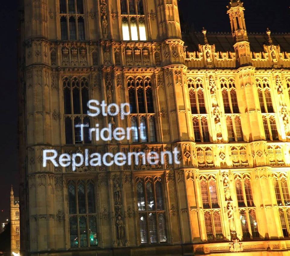 Protest group Feral X projects slogans onto the side of the Palace of Westminster. Image/ Feral X