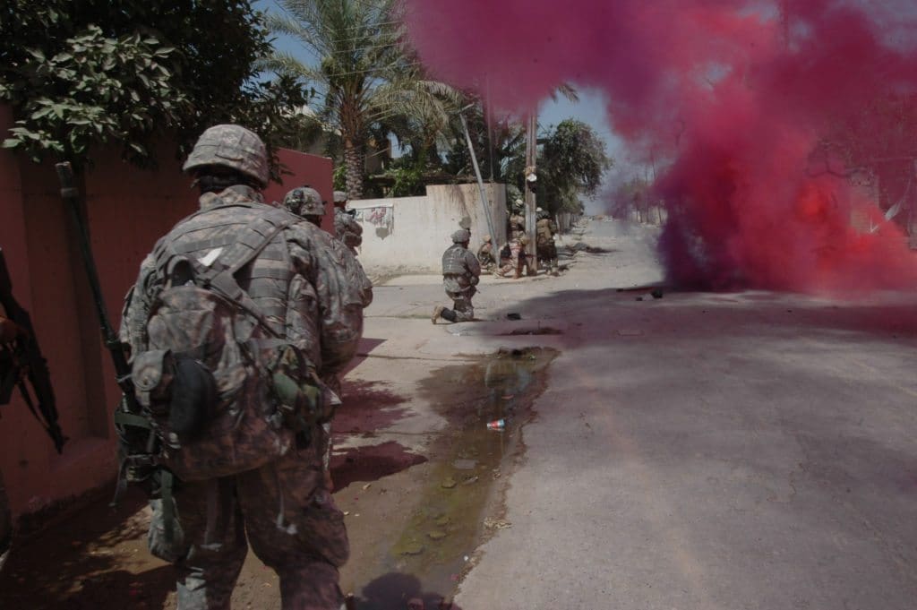 Soldiers from the 5th Iraqi Army Division, run through a smoke screen in Baqubah, Iraq, June 22, as Soldiers from the 3rd Stryker Brigade Combat Team, 2nd Infantry Division, from Fort Lewis, Wash., follow. The action was part of Operation Arrowhead Ripper, a joint effort between U.S. and Iraqi security forces to defeat al-Qaida terrorists and secure the city.