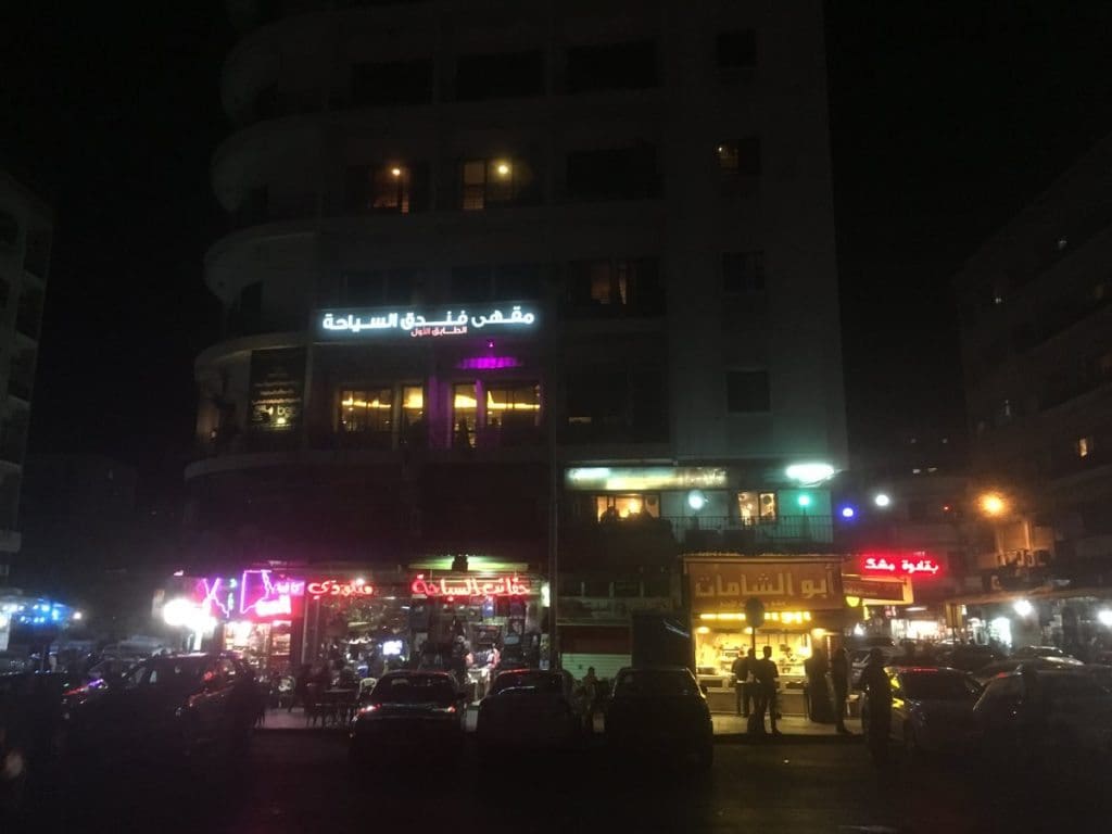 The nondescript Karnak Bar on Martyr's Square in Damascus, Syria (thin second level balcony on the right). Author's photo, 2016.