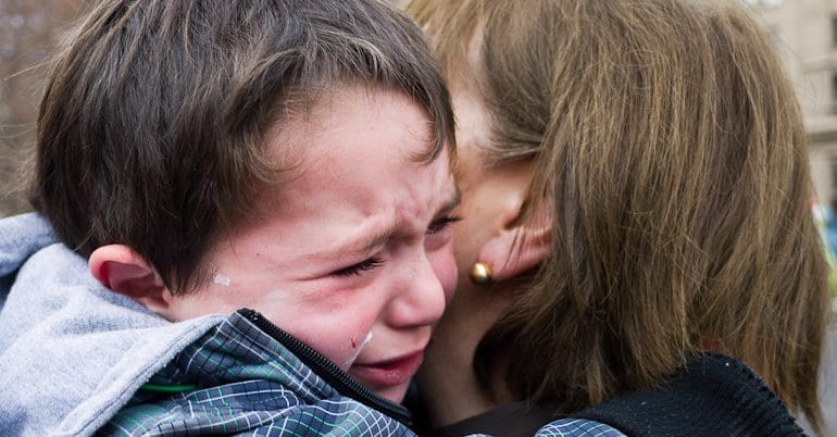 A child crying in his mother's arms child poverty People's Assembly