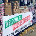 Tins of food with a banner that says "Welcome to food bank Britain"