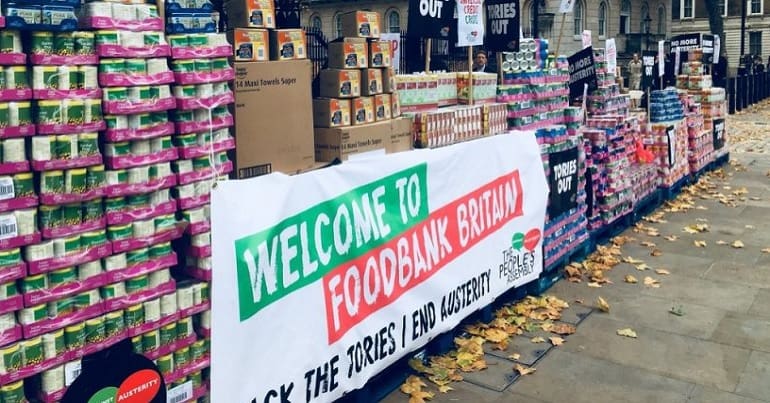 Tins of food with a banner that says "Welcome to food bank Britain"