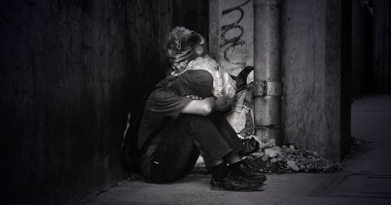 monochrome photo of a homeless man