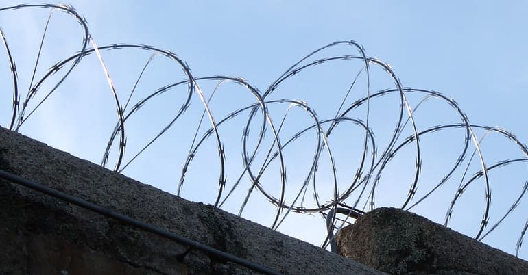 Barbed wire on prison wall