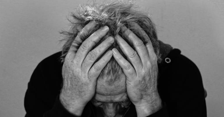 man with his head in his hands