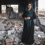 Kurdish Woman standing in bomb wreckage, Cizre