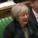 Theresa May laughing
