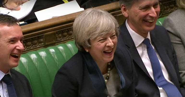 Theresa May laughing