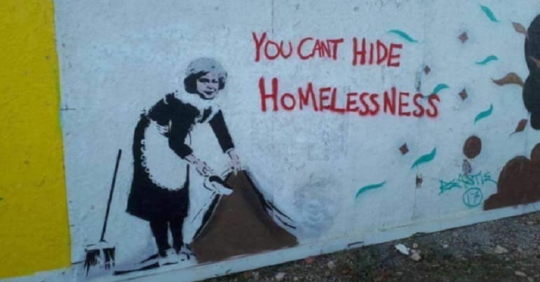 'you can't hide homelessness' graffiti