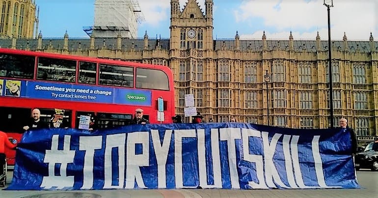 Disabled people protesting outside parliament over government cuts