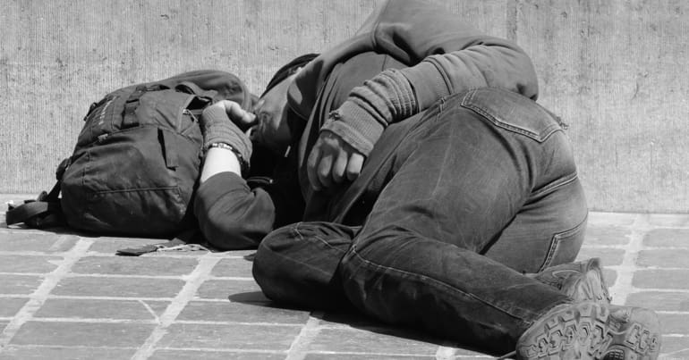 A homeless person sleeping on the street