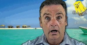 A surprised-looking middle-aged man on a desert island