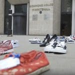 pairs of shoes arranged on the pavement - A Millions Missing protest outside the UK department of health