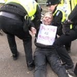 A fracking protestor being dragged away by police