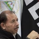 President Daniel Ortega in front of Nicaragua and FSLN flags