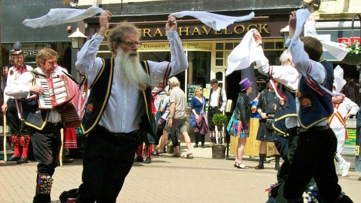 A group of morris dancers waving their hankies