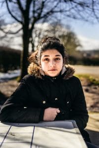 Young woman sitting outside