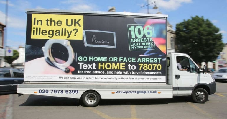 A van with 'go home or face arrest' message