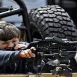 Child handels machine gun at Armed Forces Day 23 June 2018