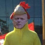 Protester in a Chris Grayling mask and a chicken suit during the Labour rail campaign day