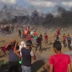 Palestinian protestors fleeing from tear gas