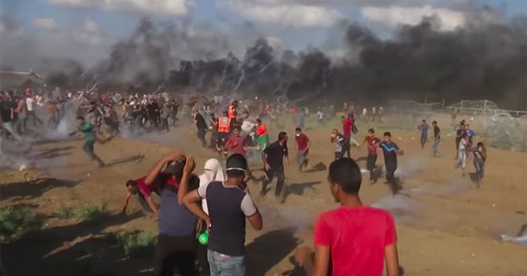 Palestinian protestors fleeing from tear gas