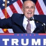 Giuliani in front of American flags