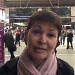 Caroline Lucas speaking to the camera at a train station