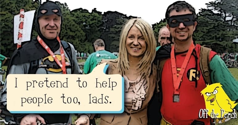 Esther McVey standing with two men dressed as Batman and Robin. She's saying: "I pretend to help people too, lads"