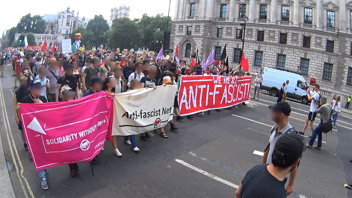 Three banners at the front of an anti-fascist march