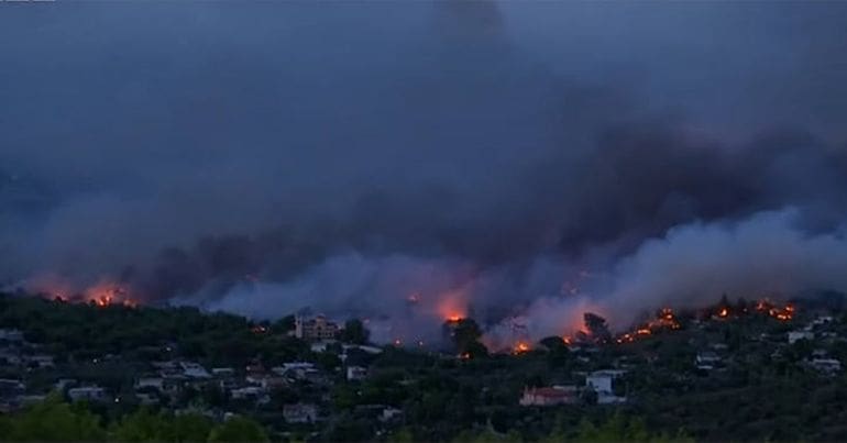 A wildfire burns a village in Greece