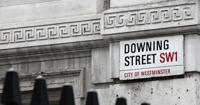 Downing Street sign above railings