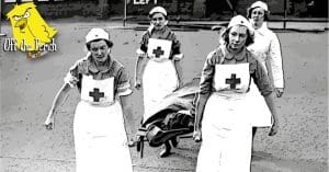 A woman on a stretcher being carried by nurses