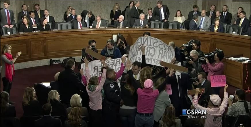 Code Pink protestors at Senate Hearing calling for prosecution of Henry Kissinger for war crimes