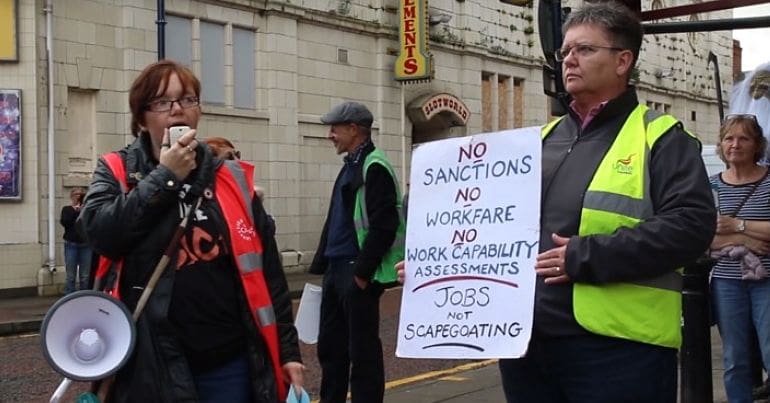 Charlotte Hughes protesting outside Ashton-under-Lyne job centre