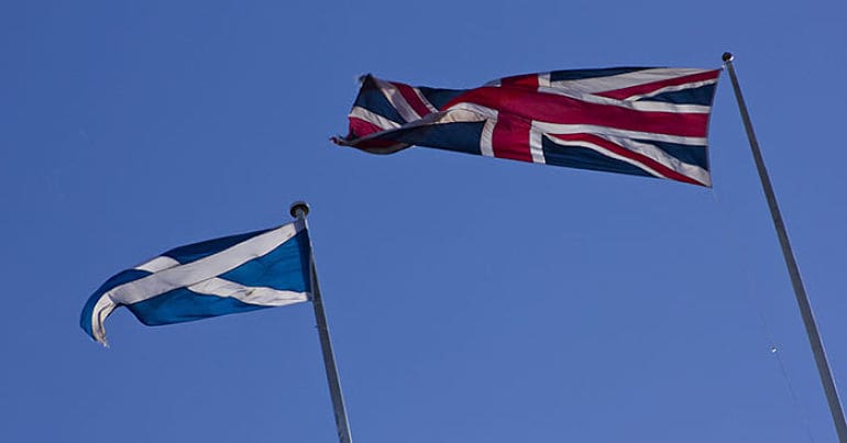 Scottish flag and UK flag flying in Edinburgh