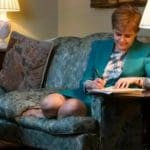 Nicola Sturgeon signing a letter to Theresa May