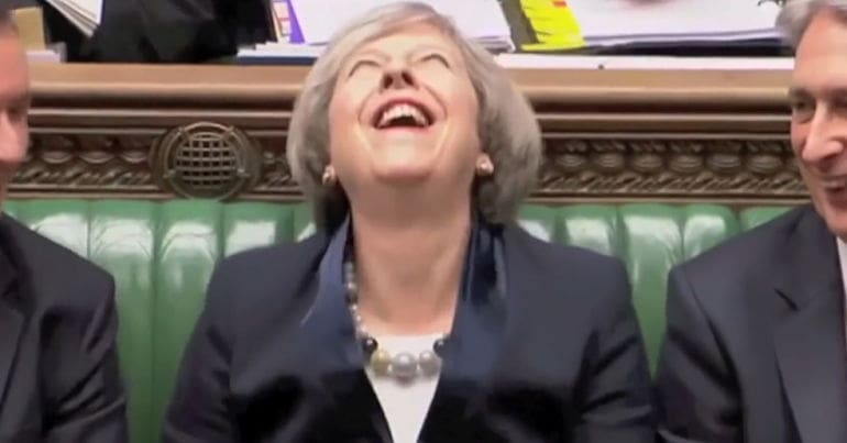 Theresa May laughing