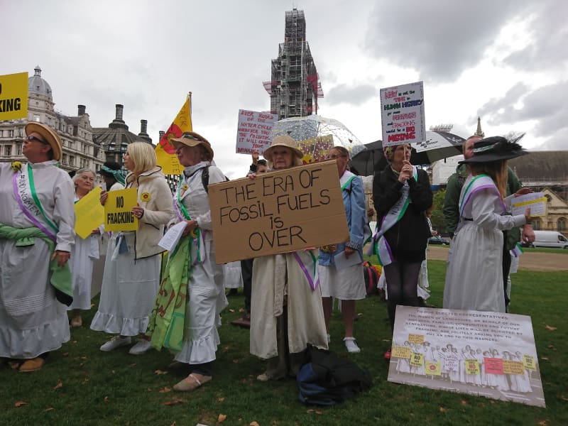A woman holding an anti fracking placard