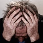 Man with head in hands