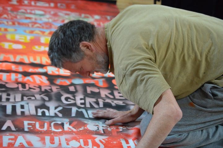 Vince Laws painting shrouds for A Very Queer Nazi Faust