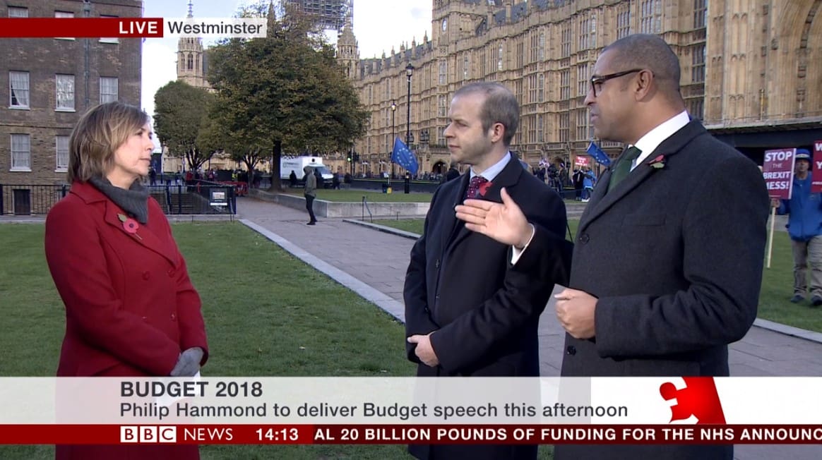 A Brexit protester coming into shot on BBC News