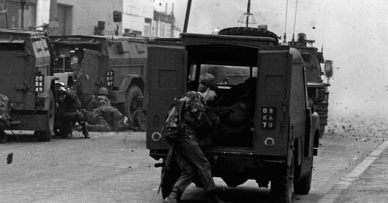British soldiers exiting a military vehicle during conflict in Northern Ireland