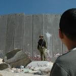 Israel-Palestine wall with soldier and child in front