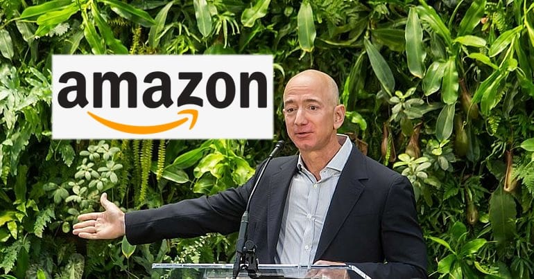 Jeff Bezos pictured in 2018, along with the Amazon logo