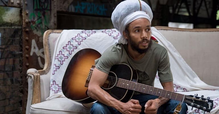 Natty holding his guitar