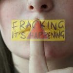 A woman hushing her mouth and an anti-fracking logo