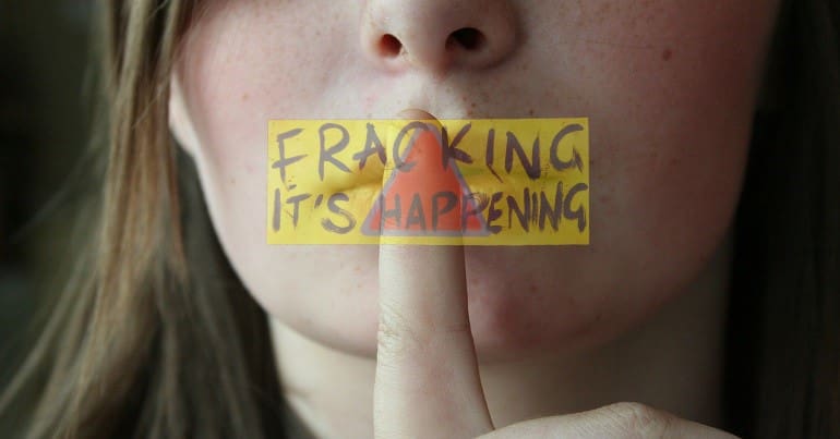 A woman hushing her mouth and an anti-fracking logo