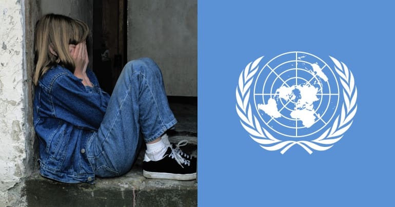 Girl with her head in her hands and UN logo
